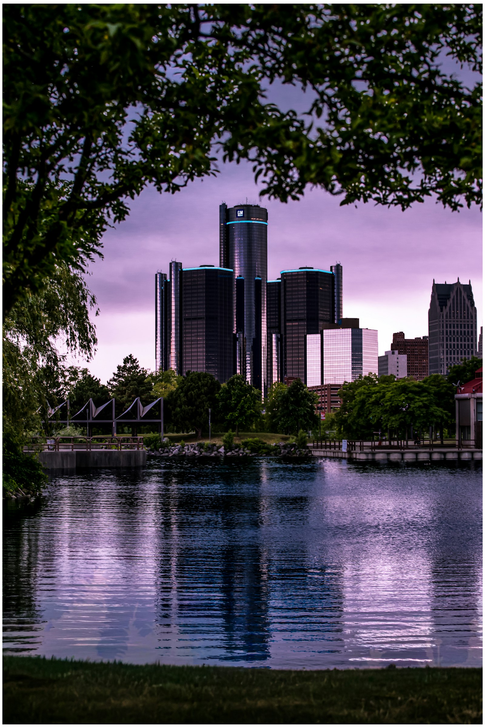 Waterfront buildings framed by trees in Detroit