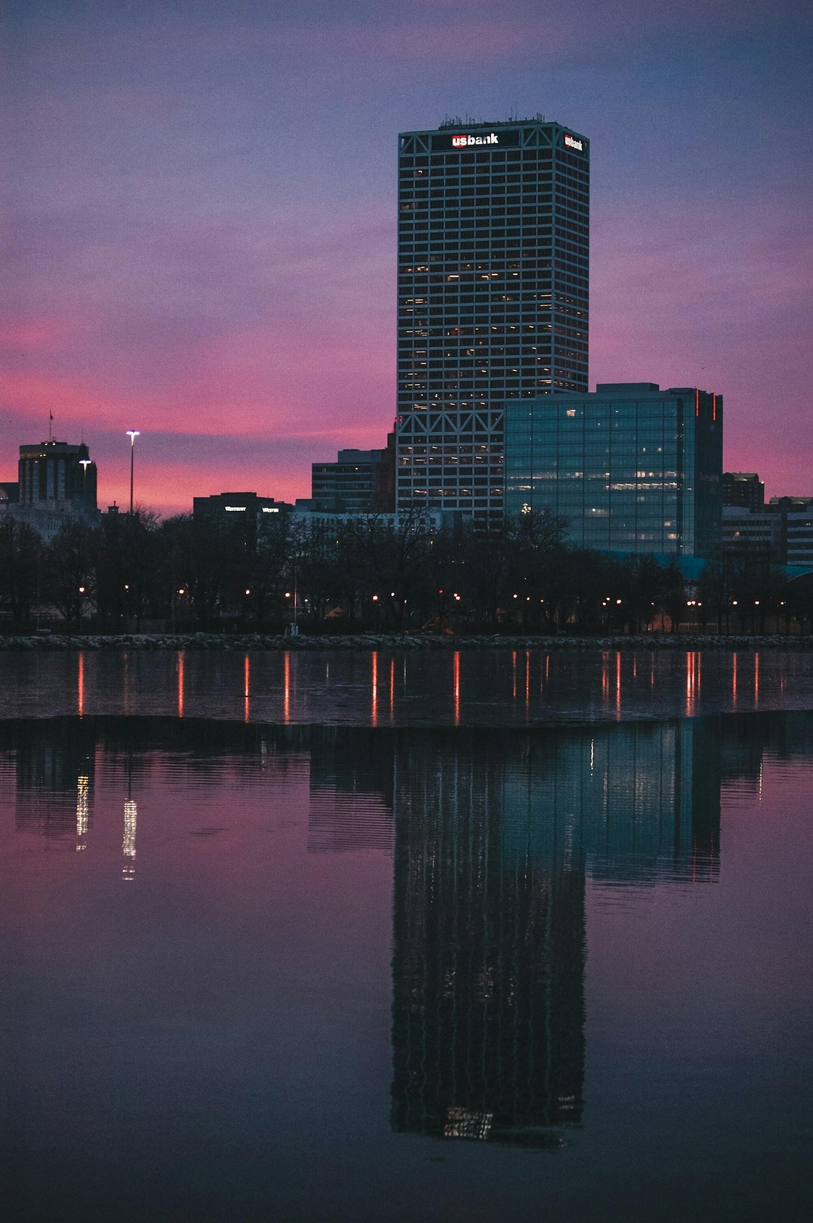 Milwaukee buildings reflected in the water at dusk